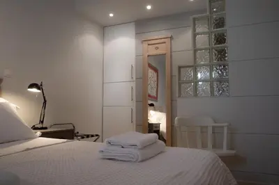 a bedroom with a bed with towels on it at Bright Gem in Vibrant Popular Neighborhood in Athens