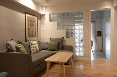 a living room with a couch and a table at Bright Gem in Vibrant Popular Neighborhood in Athens