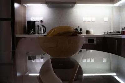 a bowl of bananas sitting on a glass table in a kitchen at Bright Gem in Vibrant Popular Neighborhood in Athens
