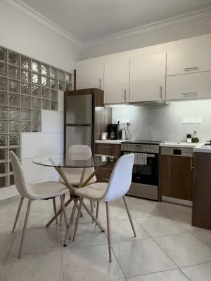 a kitchen with a glass table and two chairs at Bright Gem in Vibrant Popular Neighborhood in Athens