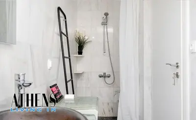 a bathroom with a shower with a sink and a mirror at Classic Residence B2 apt - 6ppl in Athens