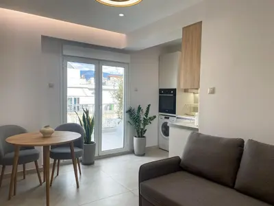a living room with a couch and a table at Modern Athens Apartment with Large Private Balcony in Athens