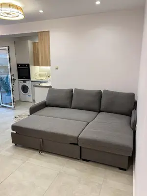 a couch in a living room with a kitchen at Modern Athens Apartment with Large Private Balcony in Athens
