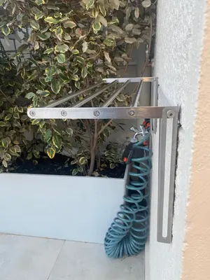 a garden hose hooked up to a wall at Modern Athens Apartment with Large Private Balcony in Athens