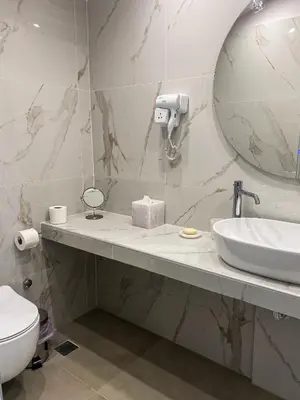 a bathroom with a sink and a mirror and a toilet at Modern Athens Apartment with Large Private Balcony in Athens