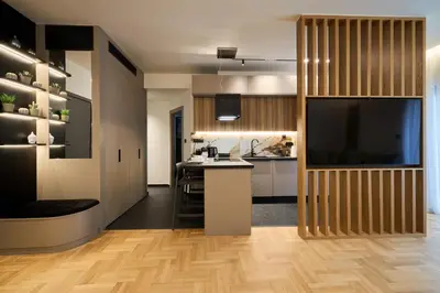 a kitchen with wooden floors and a large screen tv at Kolonaki Silent Elegance in Athens