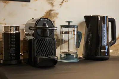 a kitchen counter with a blender and a coffee maker at Kolonaki Silent Elegance in Athens