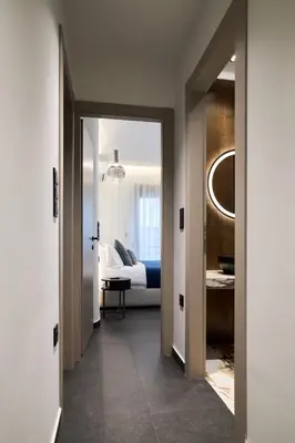 a hallway leading to a bedroom with a bed at Kolonaki Silent Elegance in Athens