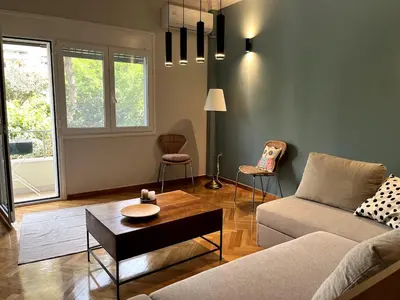 a living room with a couch and a table at Lovely, brand new, central , Modern appt Athenes - Axelle Place in Athens