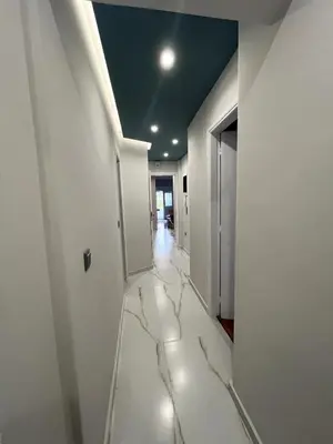 a hallway with marble floors and a blue ceiling at Lovely, brand new, central , Modern appt Athenes - Axelle Place in Athens
