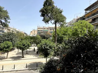 a park with trees and buildings in a city at Lovely, brand new, central , Modern appt Athenes - Axelle Place in Athens