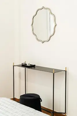 a mirror above a glass table with a black chair at Filoxenia MG Projects Eggeli Athens in Athens