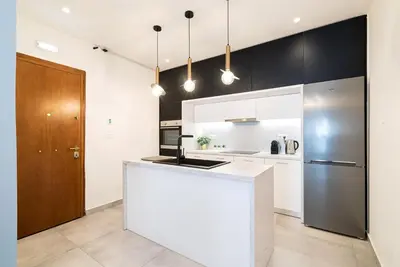 a kitchen with a white counter and a refrigerator at Filoxenia MG Projects Eggeli Athens in Athens