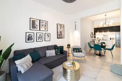 a living room with a couch and a dining room at Filoxenia MG Projects Eggeli Athens in Athens