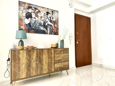 a living room with a painting on the wall at 3BD next to National Archaeological Museum in Athens