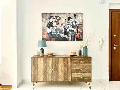 a living room with a painting on the wall at 3BD next to National Archaeological Museum in Athens