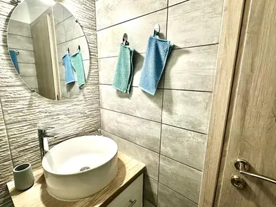 a bathroom with a sink and a mirror at 3BD next to National Archaeological Museum in Athens
