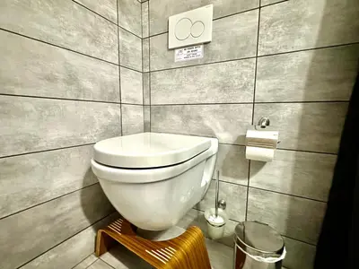 a bathroom with a white toilet in a room at 3BD next to National Archaeological Museum in Athens