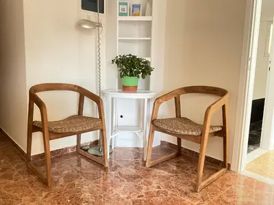 two chairs sitting next to a table with a plant on it at Quiet, Sunny & Terrace with Acropolis View in Athens