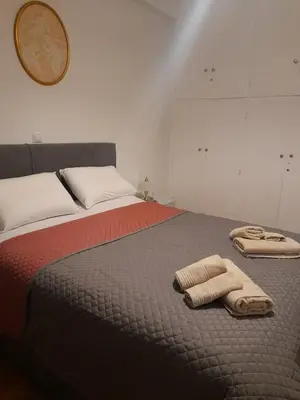 a bedroom with a bed with two towels on it at Alex house Athens in Athens