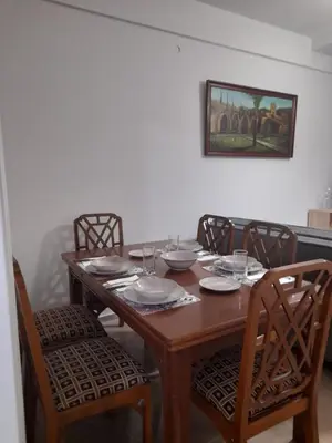 a wooden dining room table with chairs and a picture on the wall at Alex house Athens in Athens