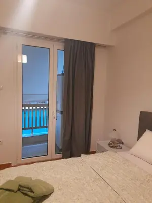a bedroom with a bed and a window with a view at Alex house Athens in Athens