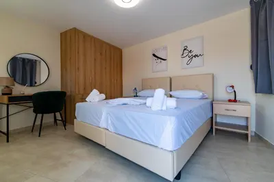 a bedroom with a bed with a desk and a mirror at Elegant Flats in Historic Centre in Athens