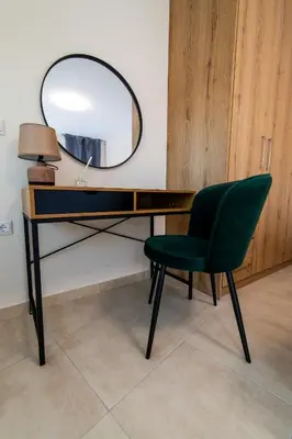 a desk with a green chair and a mirror at Elegant Flats in Historic Centre in Athens