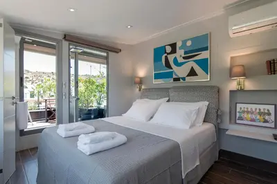 a bedroom with a bed with two towels on it at Breathtaking Penthouse Vouliagmeni in Athens