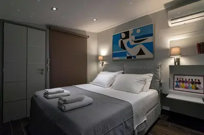 a bedroom with a bed with towels on it at Breathtaking Penthouse Vouliagmeni in Athens