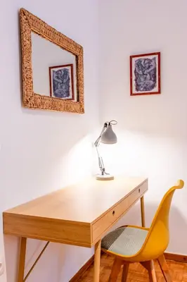 a desk with a lamp and a yellow chair at Modern 2-Bedroom Apt in Athens in Athens