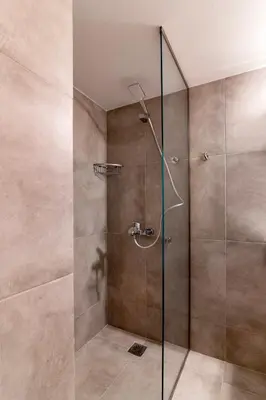 a bathroom with a shower with a glass door at Modern 2-Bedroom Apt in Athens in Athens