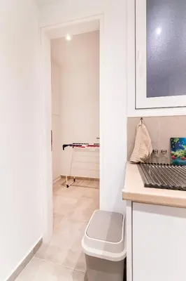 a white bathroom with a toilet and a sink at Modern 2-Bedroom Apt in Athens in Athens