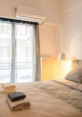 a bedroom with a bed with two towels on it at Modern 2-Bedroom Apt in Athens in Athens