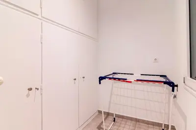 a bathroom with white walls and a walk in shower at Modern 2-Bedroom Apt in Athens in Athens