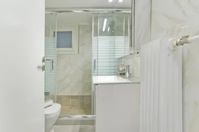 a bathroom with a shower and a sink and a toilet at Serra Relaxing Renovated Apt by Marina & Beach in Piraeus