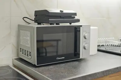 a microwave sitting on top of a counter at Serra Relaxing Renovated Apt by Marina & Beach in Piraeus