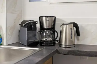 a kitchen counter with a coffee maker and a blender at Serra Relaxing Renovated Apt by Marina & Beach in Piraeus