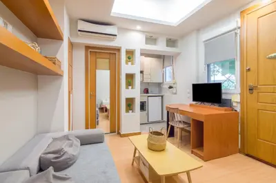 a living room with a couch and a desk at Secret Base In Central Athens in Athens