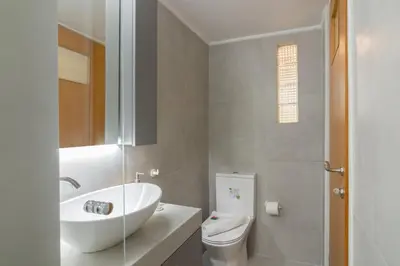 a white bathroom with a sink and a toilet at Secret Base In Central Athens in Athens