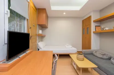 a living room with a couch and a flat screen tv at Secret Base In Central Athens in Athens
