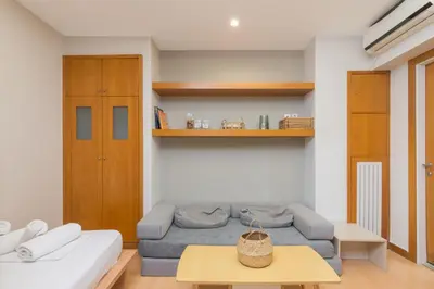 a living room with a couch and a table at Secret Base In Central Athens in Athens