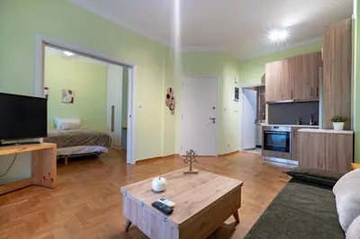 a living room with a couch and a bed and a table at Central Athens Apt Street View by MPS in Athens