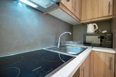 a kitchen with a sink and a microwave at Central Athens Apt Street View by MPS in Athens