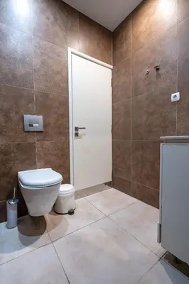 a bathroom with a white toilet and a shower at Central Athens Apt Street View by MPS in Athens