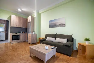 a living room with a couch and a coffee table at Central Athens Apt Street View by MPS in Athens