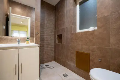 a bathroom with a toilet and a sink and a mirror at Central Athens Apt Street View by MPS in Athens