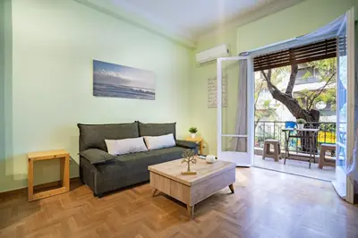 a living room with a couch and a coffee table at Central Athens Apt Street View by MPS in Athens