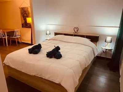 two teddy bears sitting on top of a bed at Chambres Élysées in Athens
