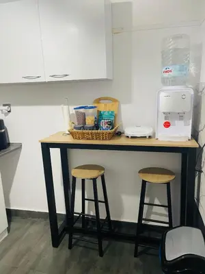 a kitchen counter with two stools and a counter top at Chambres Élysées in Athens